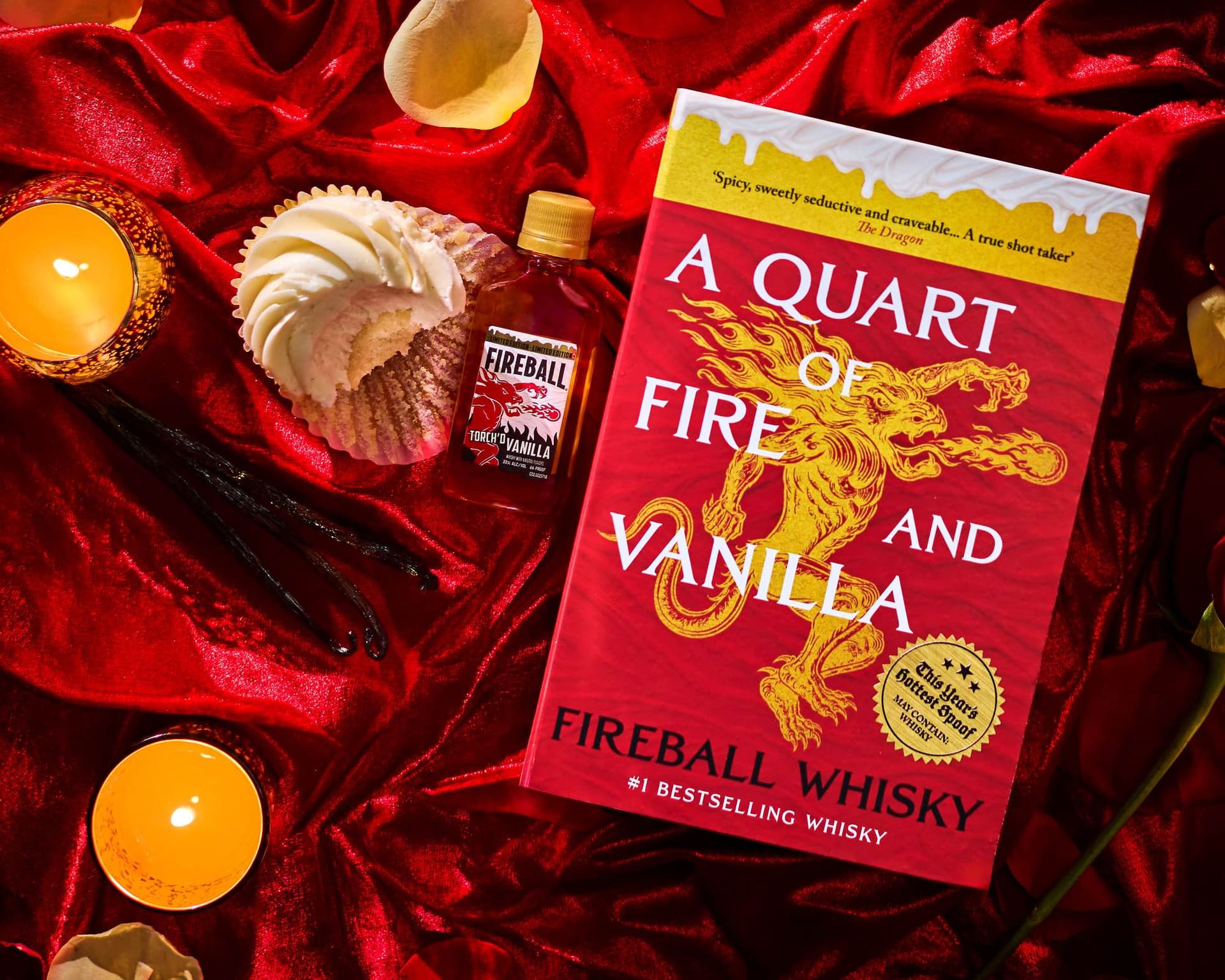 The Fireball Vanilla Smut Stash book beside a bottle of Fireball Torch'd Vanilla on red velvet