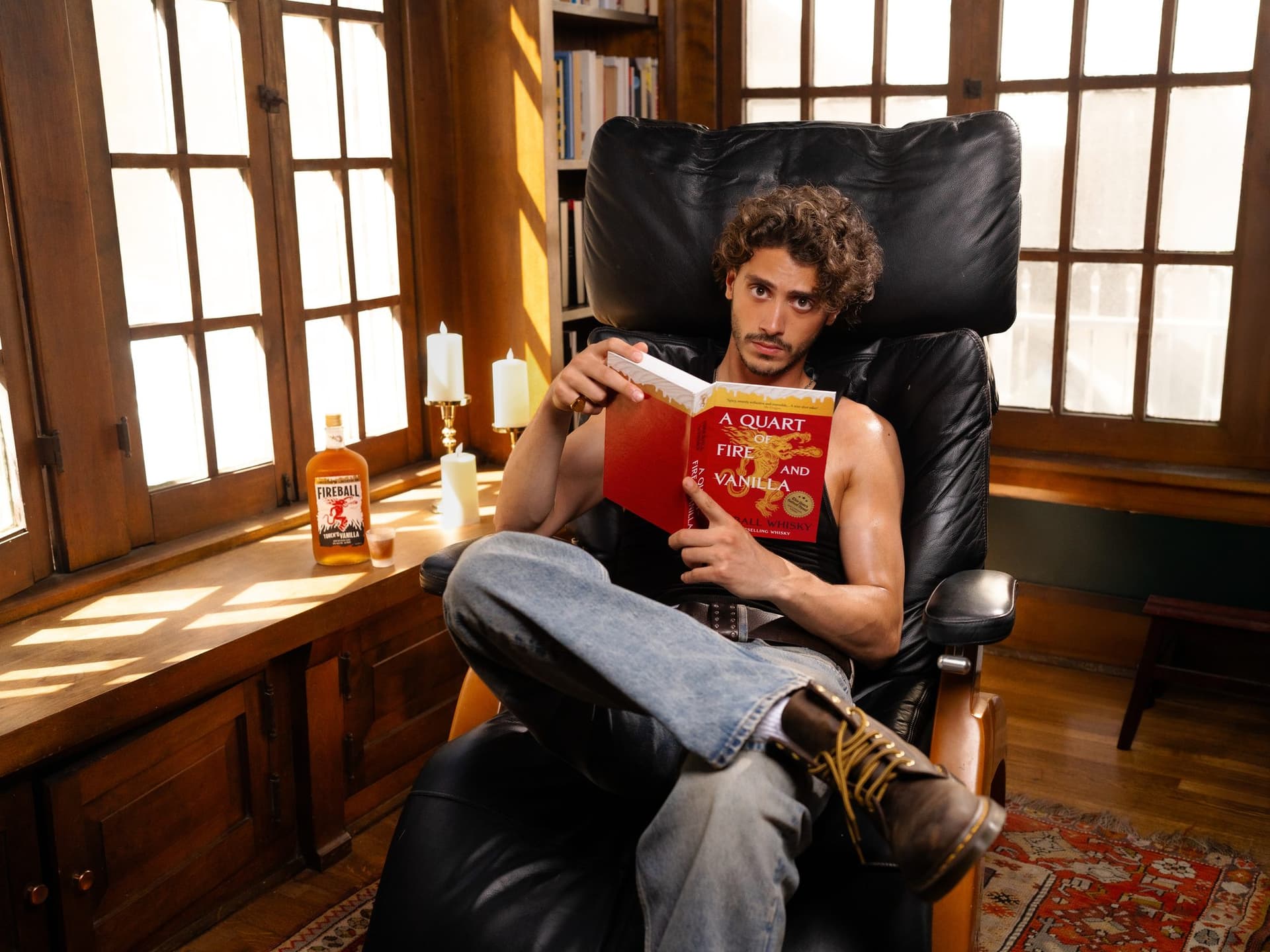 Reading the Smut Stash in a leather armchair, a bottle of Fireball on the windowsill